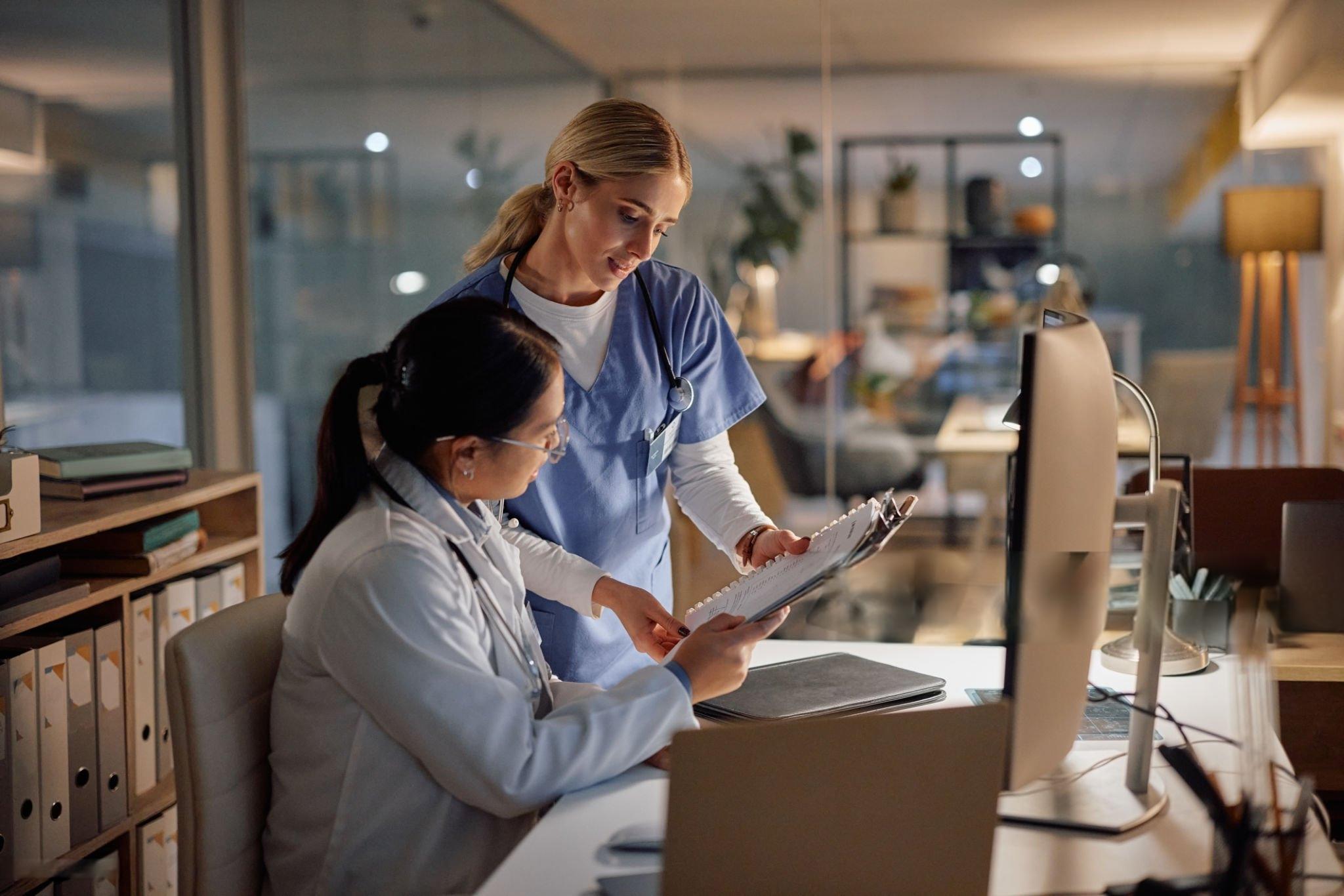 Nurse reviewing discharge paperwork with a patient at home