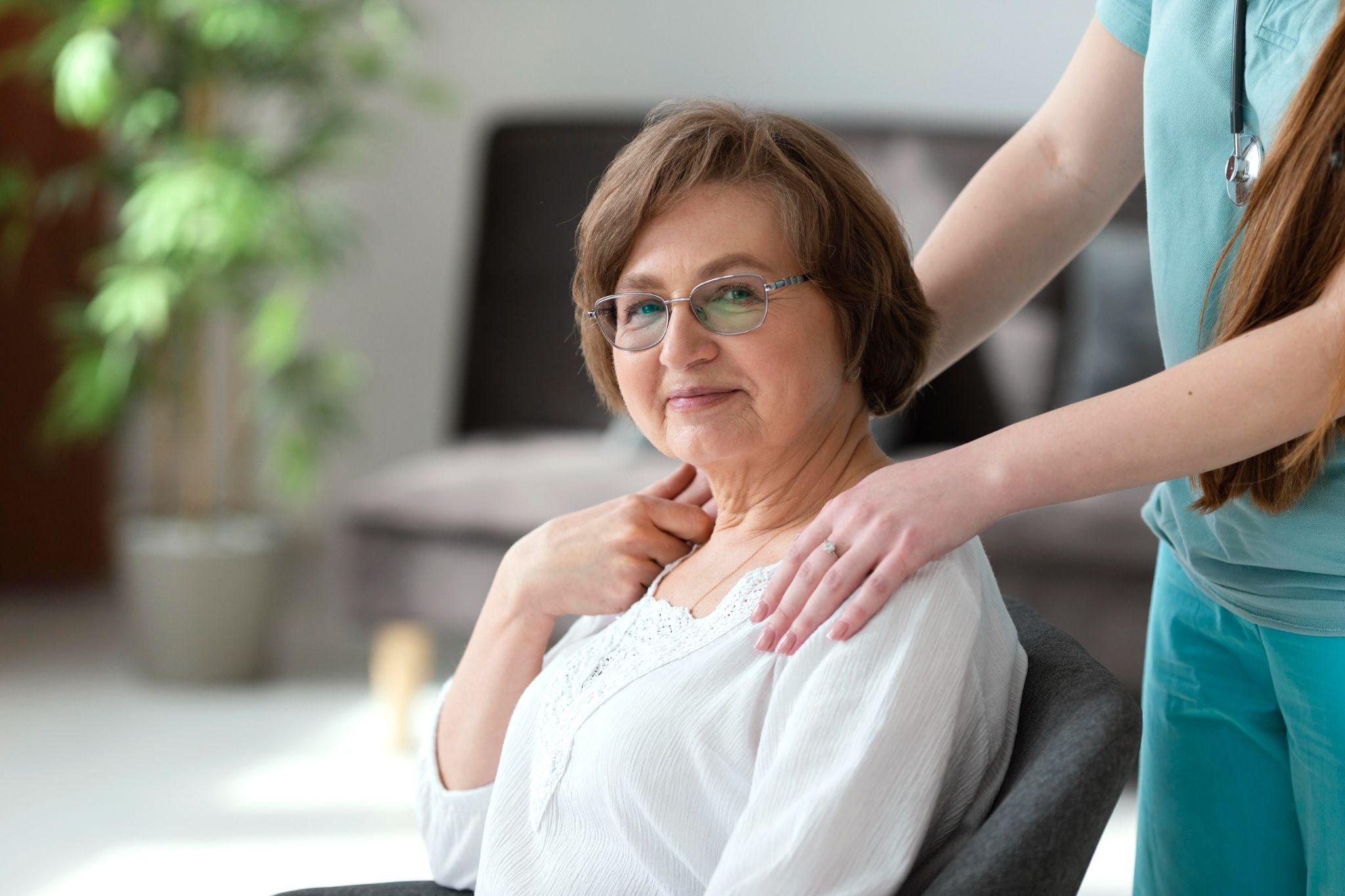 caregiver providing emotional support to a senior woman in a comfortable home care setting