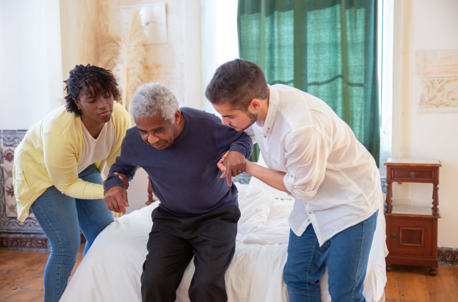 A caregiver helps a senior stand safely with support from a personal care assistant in NJ.